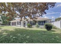 Single-story home with gray exterior, landscaping, and spacious yard at 3960 Lema Dr, Spring Hill, FL 34609