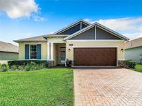 House exterior with a brown garage door and blue shutters at 19492 Fort King Run, Brooksville, FL 34601