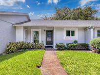 Front view of charming condo with landscaped lawn at 12205 Darwood Dr, Hudson, FL 34667