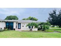 Single-story home with a well-maintained lawn and landscaping at 8141 Bugle Ct # 1, Port Richey, FL 34668