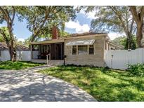 Charming single story home with a screened porch and landscaped yard at 6635 Stewart N Ave, St Petersburg, FL 33702