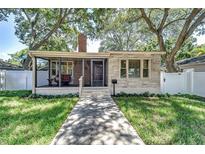 Charming bungalow with screened porch, brick accents, and a well-manicured lawn at 6635 Stewart N Ave, St Petersburg, FL 33702