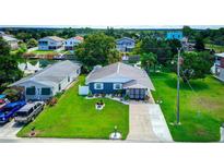 Charming home with manicured lawn, water feature, and water access, creating a serene and inviting outdoor space at 3178 Sea Grape Dr, Hernando Beach, FL 34607