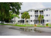 Two-story condo building with white exterior and balconies at 2077 Wetland Pt # 1103, Lutz, FL 33558