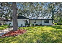 Single-story house with landscaped yard at 2004 Nobleton Ave, Spring Hill, FL 34608