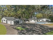 Aerial view of house, pool, and detached garage at 18101 Mason Smith Rd, Brooksville, FL 34604