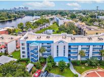 Aerial view of a waterfront condo community featuring a building with blue accents at 2424 W Tampa Bay Blvd # L-302, Tampa, FL 33607