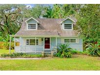 Light blue house with white porch at 14335 Snow Memorial Hwy, Brooksville, FL 34601