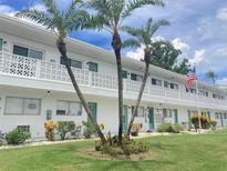 Exterior view of a light-colored apartment building with landscaping at 11200 86Th Ave # 204, Seminole, FL 33772
