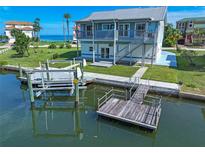 Two-story waterfront home with private dock and boat lift; ideal for boating enthusiasts at 6428 Driftwood Dr, Hudson, FL 34667