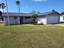 Charming single-story home with a well-maintained lawn and neat landscaping at 3544 Wilson Dr, Holiday, FL 34691