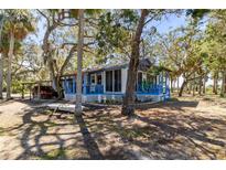 Charming waterfront cottage nestled on a shaded lot with mature trees at 8812 Camp Ln, Hudson, FL 34667