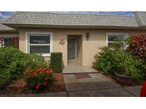 Condo exterior featuring a gray door and landscaping at 3819 Teeside Dr, New Port Richey, FL 34655