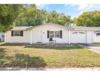 Newly renovated ranch-style home with white brick exterior and attached garage at 7240 Nova Scotia Dr, Port Richey, FL 34668