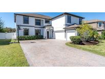 Two-story house with a brick driveway and basketball hoop at 12135 Crestridge Loop, Trinity, FL 34655