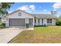 Front view of single Gathering home with two car garage at 12546 Brookside St, Spring Hill, FL 34609