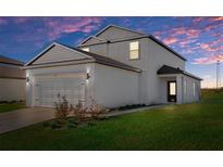 Two-story house with attached garage, landscaping, and neutral color palette at 5317 Cricket Rd, Brooksville, FL 34602