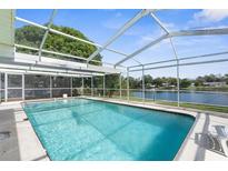 Inviting screened pool with lake view at 10316 Amadeus Dr, Port Richey, FL 34668