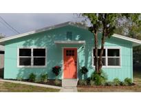 Charming light teal home with a coral door at 1943 Park Ave, Tarpon Springs, FL 34689