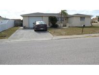 Single-story house with a driveway and garage at 7204 Westcott Dr, Port Richey, FL 34668