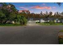 Large two-story house with a three-car garage at dusk at 7222 Auburn Ln, New Port Richey, FL 34654