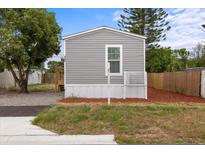 Charming single story home featuring a gray exterior, complemented by a well-maintained lawn at 4304 Buena Vista Ln, Holiday, FL 34691