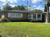 Ranch-style home with a well-maintained lawn at 7634 Topay Ln, Port Richey, FL 34668