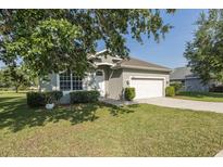 Charming single-story home featuring a well-manicured lawn, two-car garage, and welcoming curb appeal at 2293 Dog Leg Ct, Brooksville, FL 34604