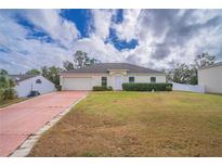 Single-story home with a paved driveway and well-maintained lawn at 4350 Talco Ave, Spring Hill, FL 34609