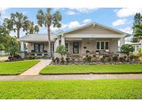 Charming craftsman home with a front porch and landscaping at 203 S Spring Blvd, Tarpon Springs, FL 34689