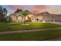 Beautiful one-story home with palm trees and well-maintained lawn at 3527 Conifer Loop, Spring Hill, FL 34609