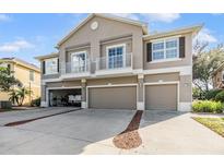 Three-story building with attached garages and balconies at 7650 Red Mill Cir, New Port Richey, FL 34653