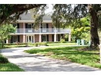 Two-story brick home with a large front porch and mature landscaping at 2303 S Hesperides St, Tampa, FL 33629