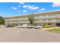 Two-story condo building with ample parking and a well-maintained exterior at 2260 Costa Rican Dr # 26, Clearwater, FL 33763