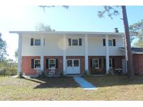 Brick ranch house with white columns and double front doors at 8700 Ross Ln, New Port Richey, FL 34654