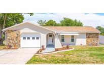 Updated single story home with a two-car garage and well-maintained lawn at 11261 Redgate St, Spring Hill, FL 34609