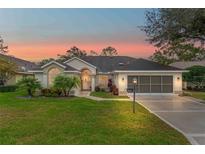 Beautiful single-story home with landscaped lawn, driveway, and two-car garage at 2362 Whisper Walk Dr, Spring Hill, FL 34606