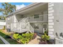 Building exterior with stairs and landscaping at 12141 Spartan Way # 204, Hudson, FL 34667