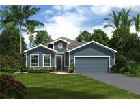 One-story home with blue siding, two-car garage, and landscaped lawn at 6032 Dropwort Dr, Wimauma, FL 33598