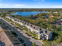 Aerial view of condo complex near a lake with lush greenery at 2210 Utopian E Dr # 212, Clearwater, FL 33763