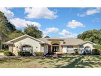 Attractive single-story home with brick accents and a well-maintained lawn at 7385 Royal Oak Dr, Spring Hill, FL 34607