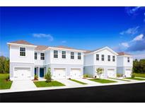 Three-unit townhome building with attached garages and landscaping at 14112 Crimson Ave, Lakewood Ranch, FL 34211