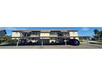 Two-story condo building with covered parking and balconies at 4901 Onyx Ln # 202, New Port Richey, FL 34652