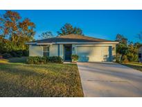 Single-story home with attached garage, landscaping, and a driveway at 5324 Dellbrook Ave, Spring Hill, FL 34608