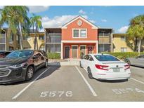 Two-story condo building with parking and lush landscaping at 5576 Baywater Dr # 5576, Tampa, FL 33615