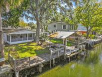 Aerial view of waterfront property with canal access and lush landscaping at 7195 Bethesda Ct, Weeki Wachee, FL 34607