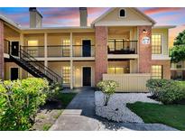 Brick condo building with balconies and stairs at 8718 Mallard Reserve Dr # 202, Tampa, FL 33614