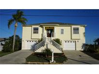Two-story house with attached two-car garage, and a manicured lawn at 13730 Gene Rossi Ave, Hudson, FL 34667