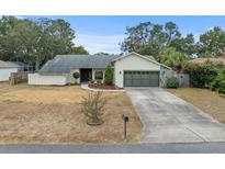 Single-story home with attached garage and landscaped yard at 2319 Canfield Dr, Spring Hill, FL 34609