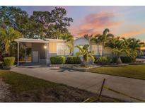 Inviting exterior of a single-story home with landscaped yard and covered entryway at 4620 Tri Par Dr, Sarasota, FL 34234